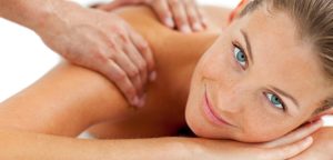 Smiling woman enjoying a massage in a spa center